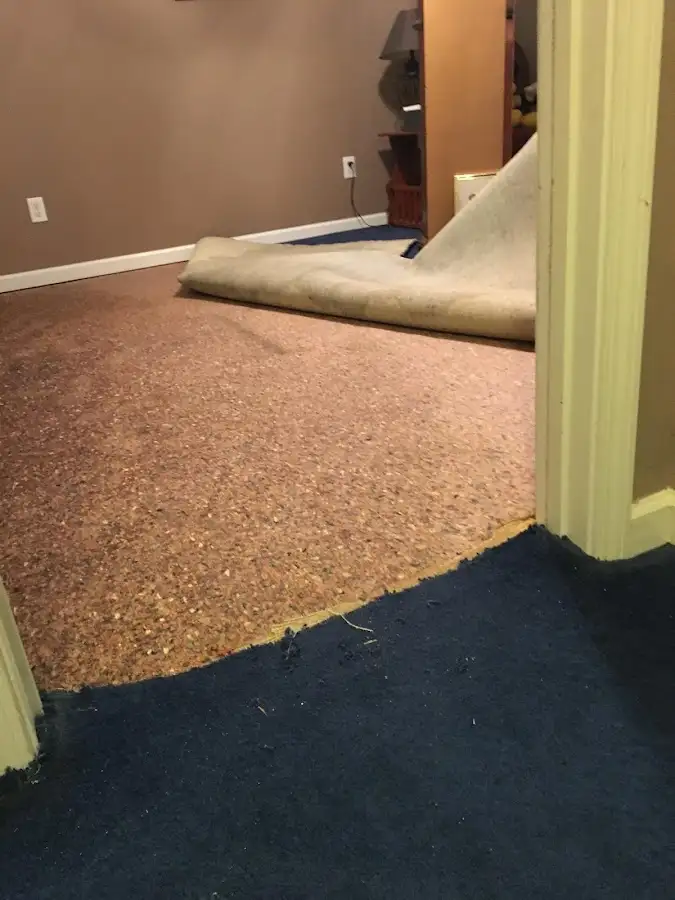 Carpet pad removal revealing water damage during Water Mitigation Services in Santa Cruz